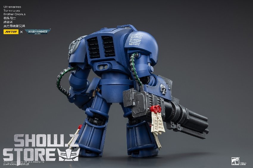 Ultramarines terminator holding heavy bolter and shield emblem markings Ultramarines terminator holding heavy bolter and shield emblem markings