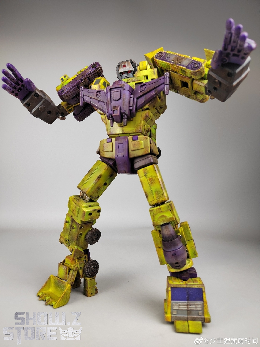 Bright yellow and purple towering robot with weathered dirt effects and tank tread legs Bright yellow and purple towering robot with weathered dirt effects and tank tread legs