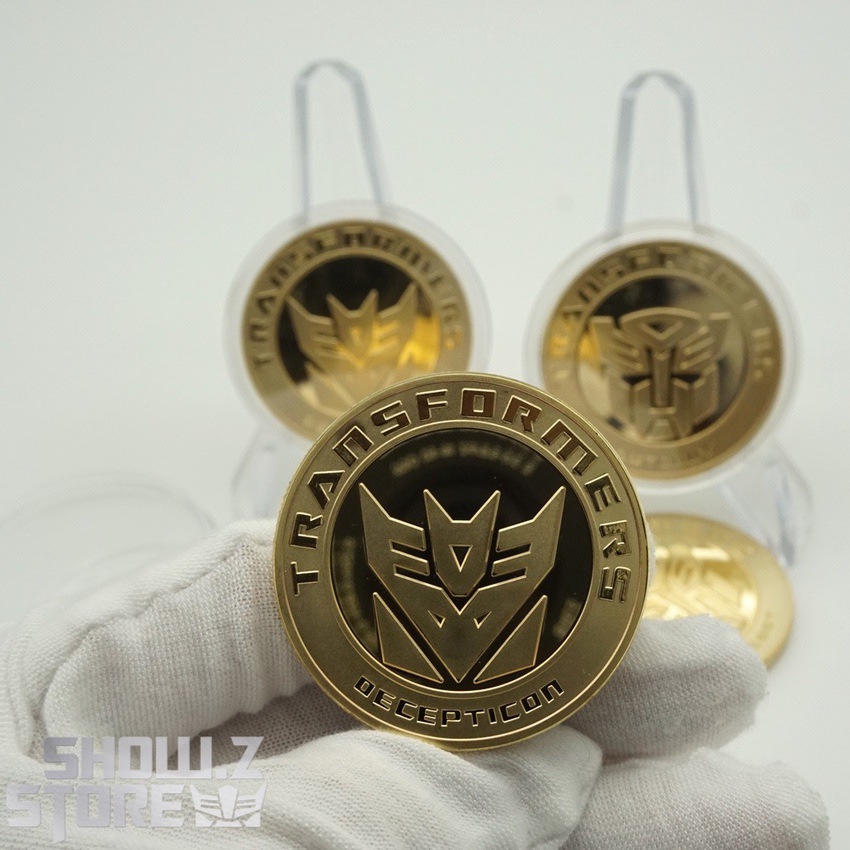 Collectible Transformers medals with both faction symbols displayed Collectible Transformers medals with both faction symbols displayed