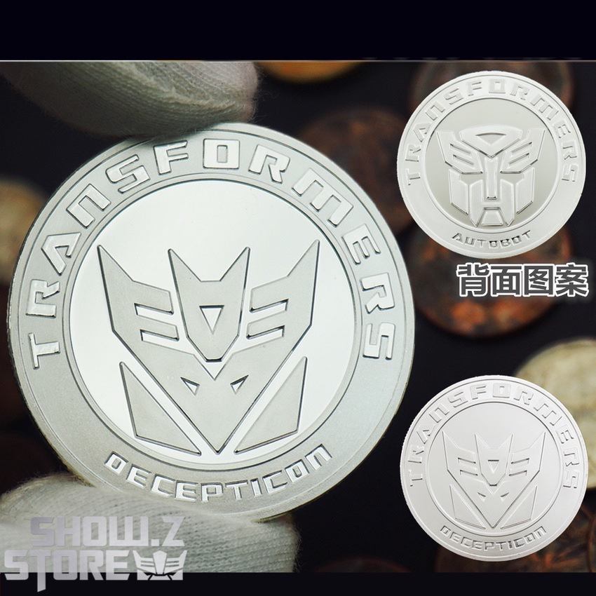 Large gold Transformers Autobot coin held in white gloved hand Large gold Transformers Autobot coin held in white gloved hand
