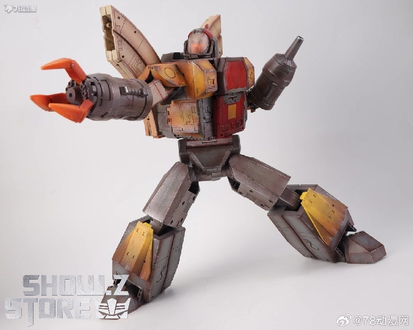 Tan brown robot with orange and yellow coloring in combat-ready standing position Tan brown robot with orange and yellow coloring in combat-ready standing position