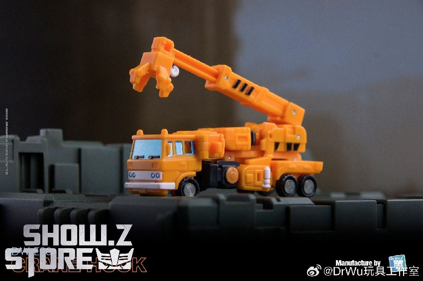 Orange and purple transformer robot in vehicle crane mode displayed Orange and purple transformer robot in vehicle crane mode displayed