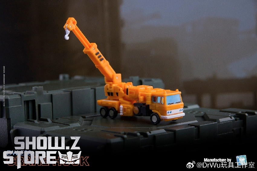 Orange construction crane truck transformer with extended articulated arm Orange construction crane truck transformer with extended articulated arm