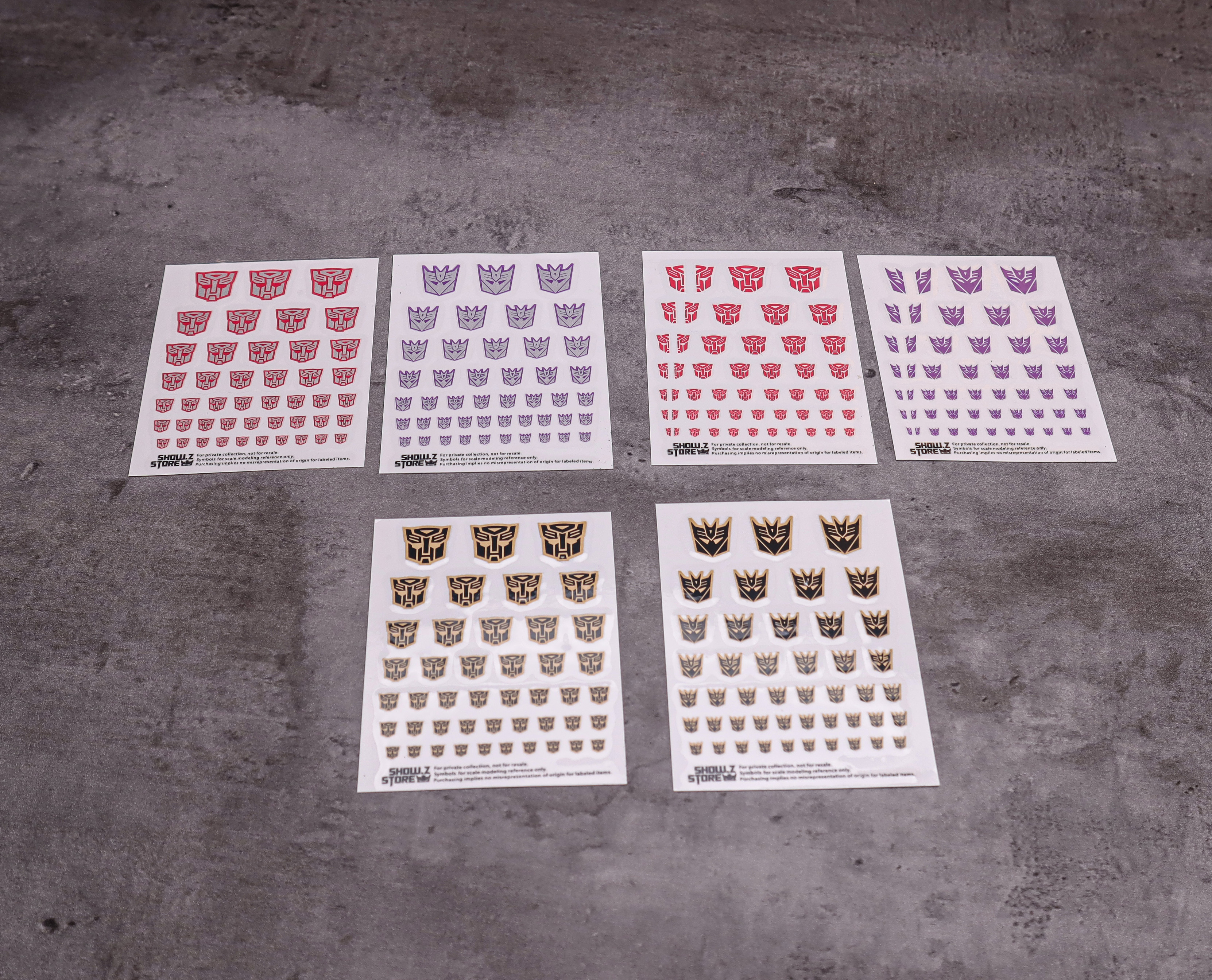 Multiple colorful Transformers faction symbol stickers in red purple yellow Multiple colorful Transformers faction symbol stickers in red purple yellow
