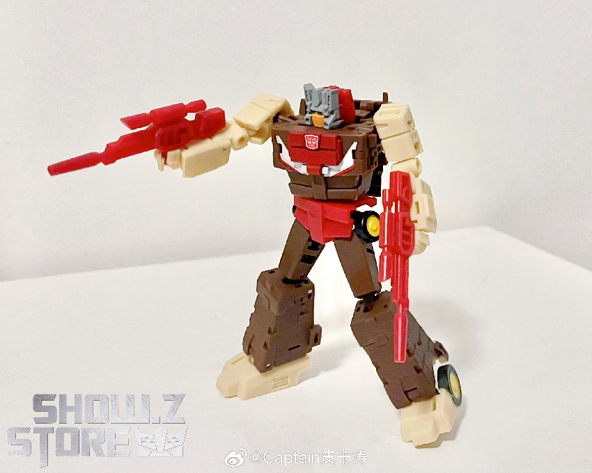 Red brown Chromedome robot figure standing with weapon raised in attack pose Red brown Chromedome robot figure standing with weapon raised in attack pose