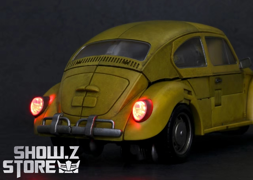 Yellow Volkswagen Beetle car with illuminated headlights Yellow Volkswagen Beetle car with illuminated headlights