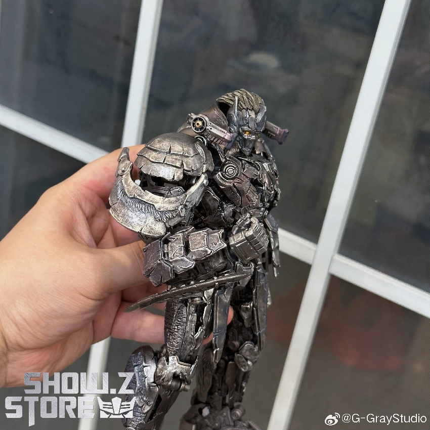 Hand-held black robot figure showing detailed sculpt and articulation Hand-held black robot figure showing detailed sculpt and articulation