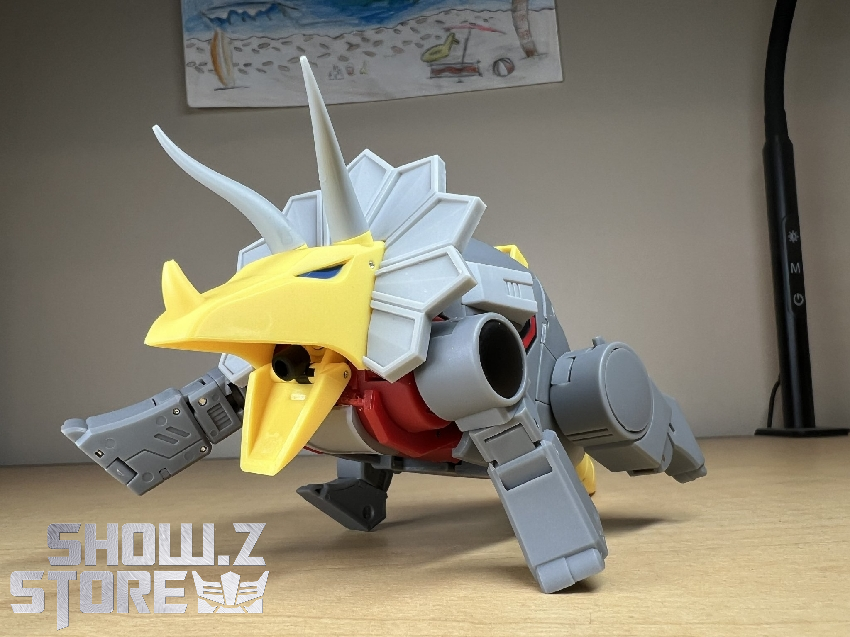 Alt view of Slag Dinobot in compact form with white and gray components Alt view of Slag Dinobot in compact form with white and gray components