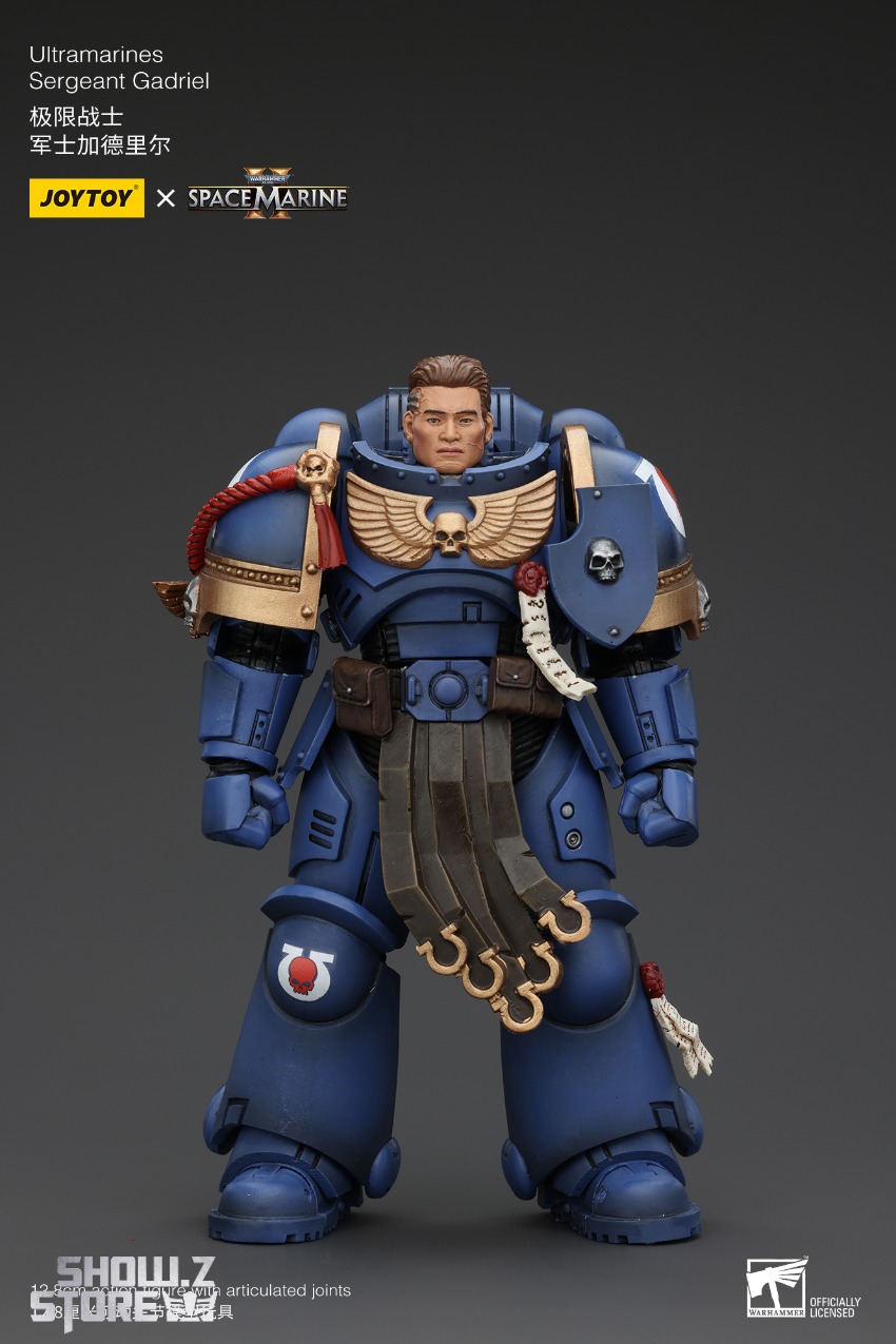 Ultramarines Sergeant blue armor red helmet stern expression Ultramarines Sergeant blue armor red helmet stern expression