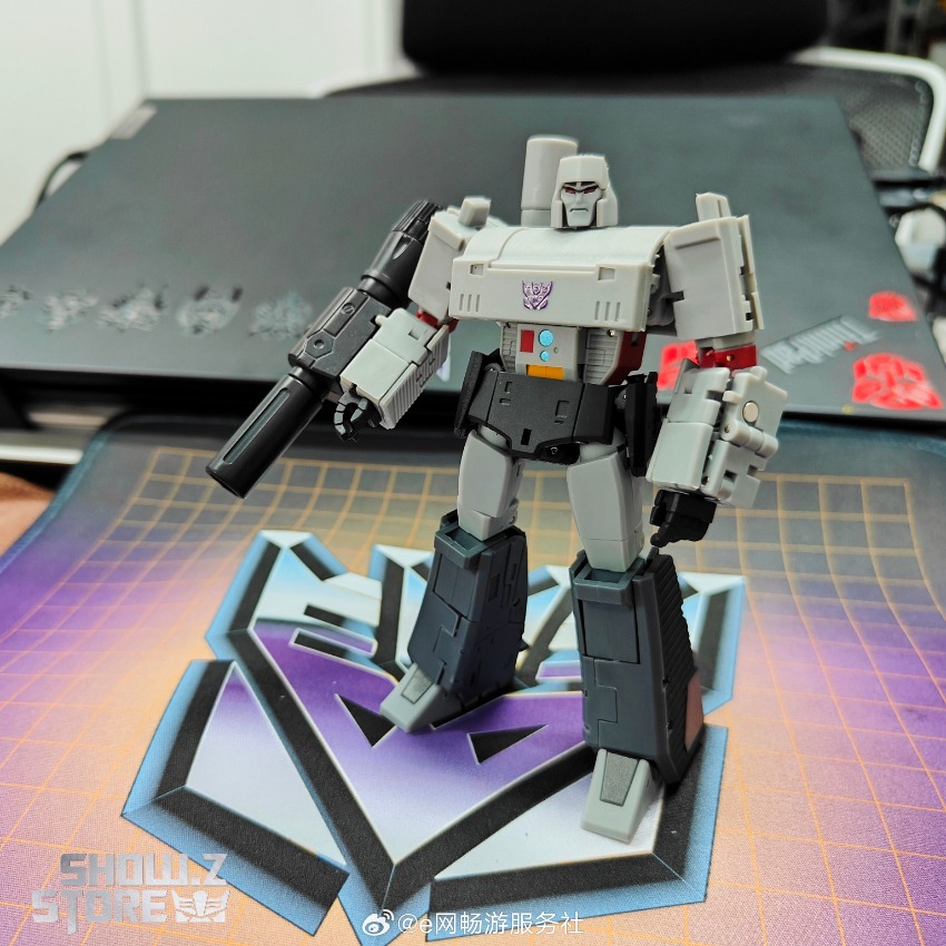 White and red Decepticon robot with purple chest emblem and articulated cannon arm White and red Decepticon robot with purple chest emblem and articulated cannon arm