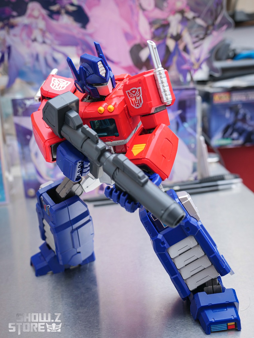 Front-facing view of red and blue Optimus Prime showing weapon details Front-facing view of red and blue Optimus Prime showing weapon details