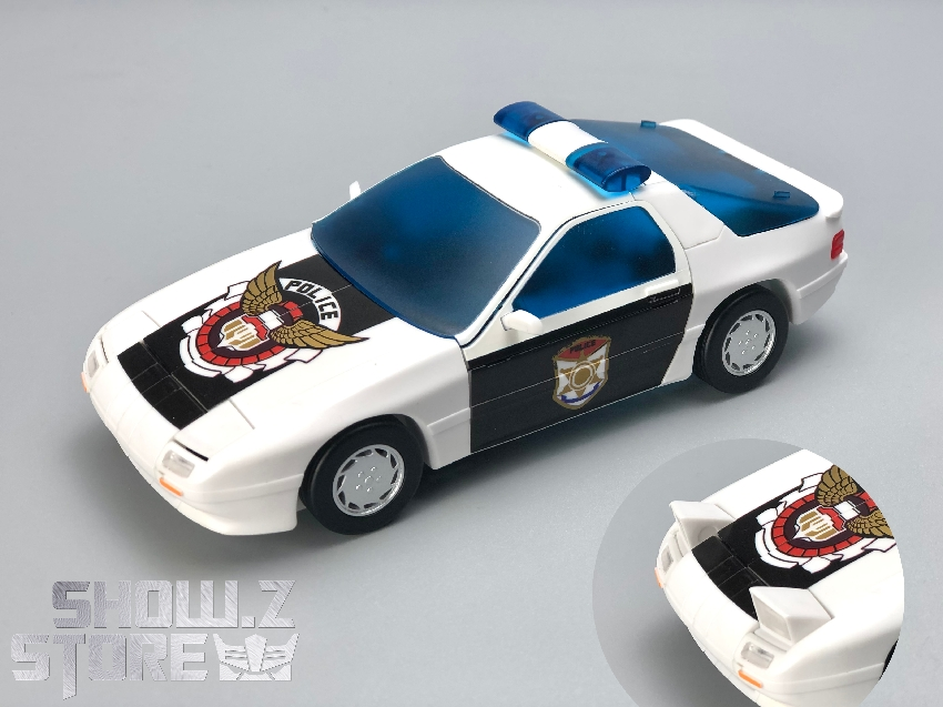 White and blue police car with number 4 in vehicle mode White and blue police car with number 4 in vehicle mode