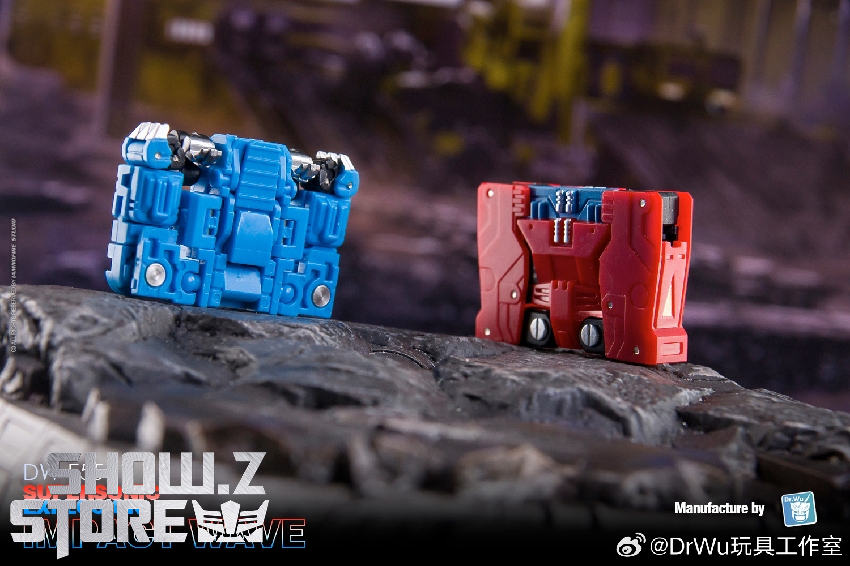 Two red and blue robot figures positioned on rocky battlefield Two red and blue robot figures positioned on rocky battlefield