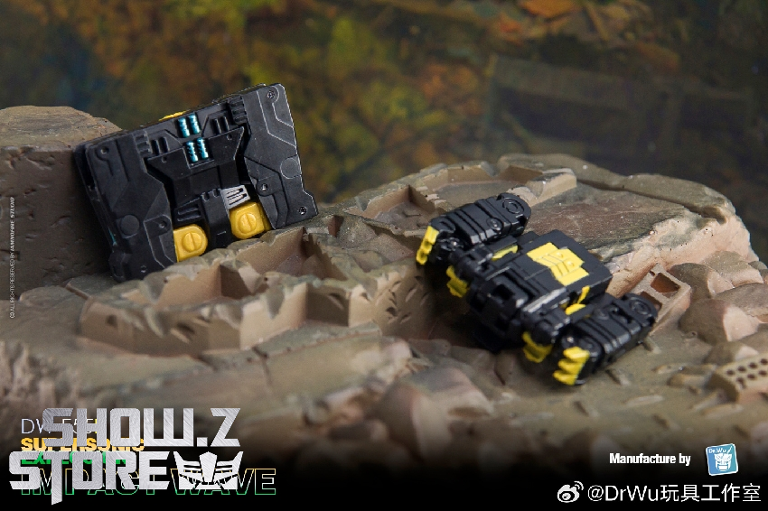 Black yellow mini-cassette Impact Wave robot in outdoor scenic mountain landscape Black yellow mini-cassette Impact Wave robot in outdoor scenic mountain landscape