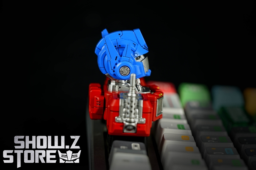 Detailed blue head red chest keycap transformer articulated parts displayed Detailed blue head red chest keycap transformer articulated parts displayed