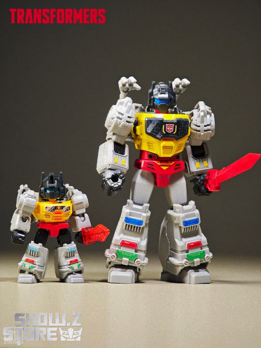 Large small white yellow red robot figures standing together display Large small white yellow red robot figures standing together display