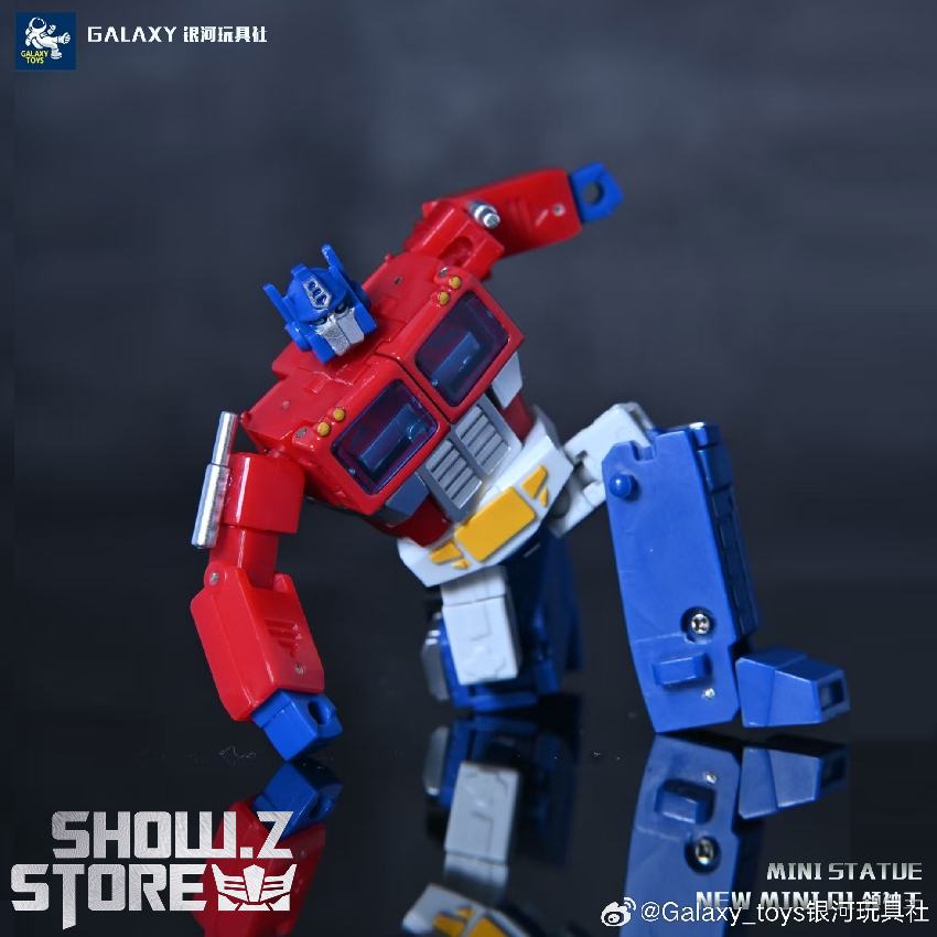 Optimus Prime robot side angle with black rifle held high Optimus Prime robot side angle with black rifle held high