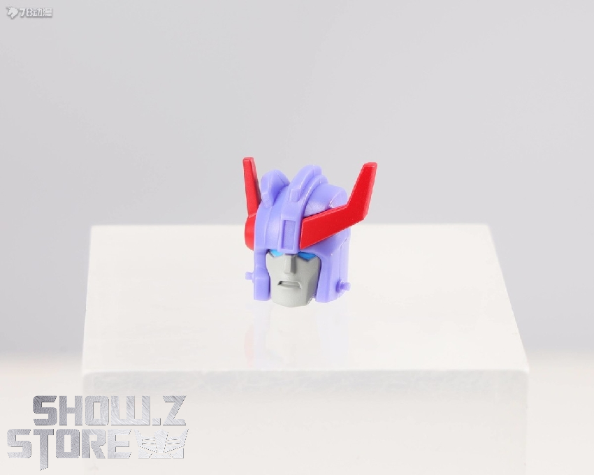 Purple and blue robot toy figure with articulated limbs on white base Purple and blue robot toy figure with articulated limbs on white base