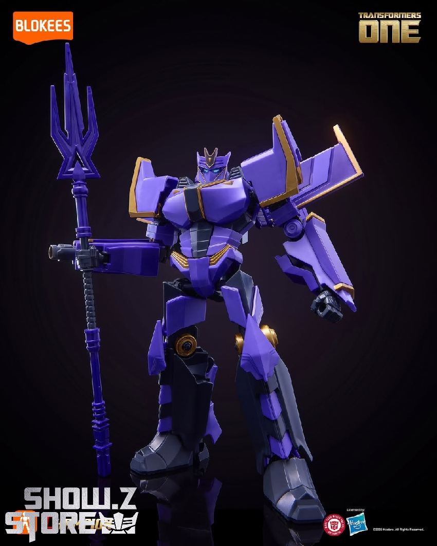 Purple and blue Transformers figure with staff weapon on dark backdrop Purple and blue Transformers figure with staff weapon on dark backdrop