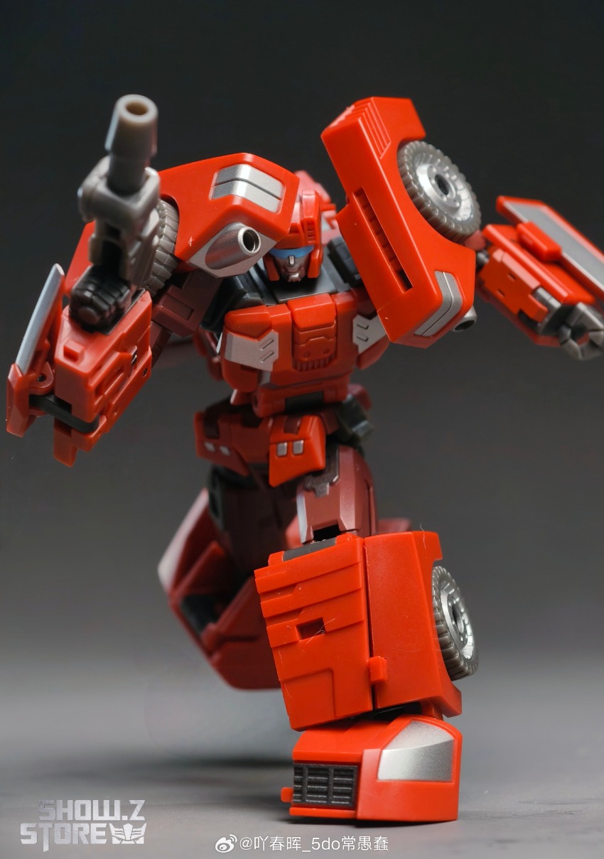 Red and white robot with spinning tires showing vehicle mode details Red and white robot with spinning tires showing vehicle mode details