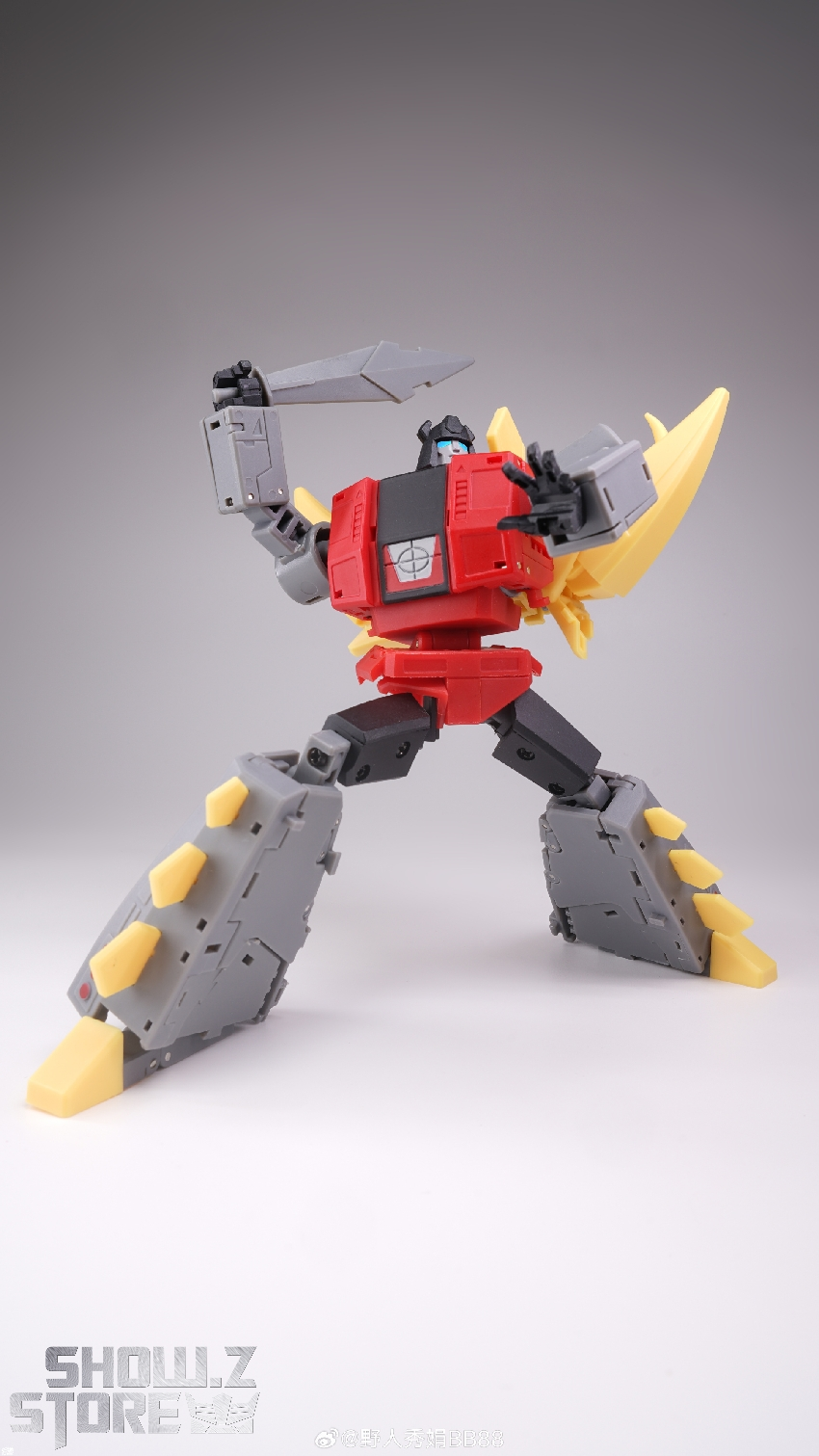 Red and gray transformer robot standing upright with extended yellow tail spikes Red and gray transformer robot standing upright with extended yellow tail spikes