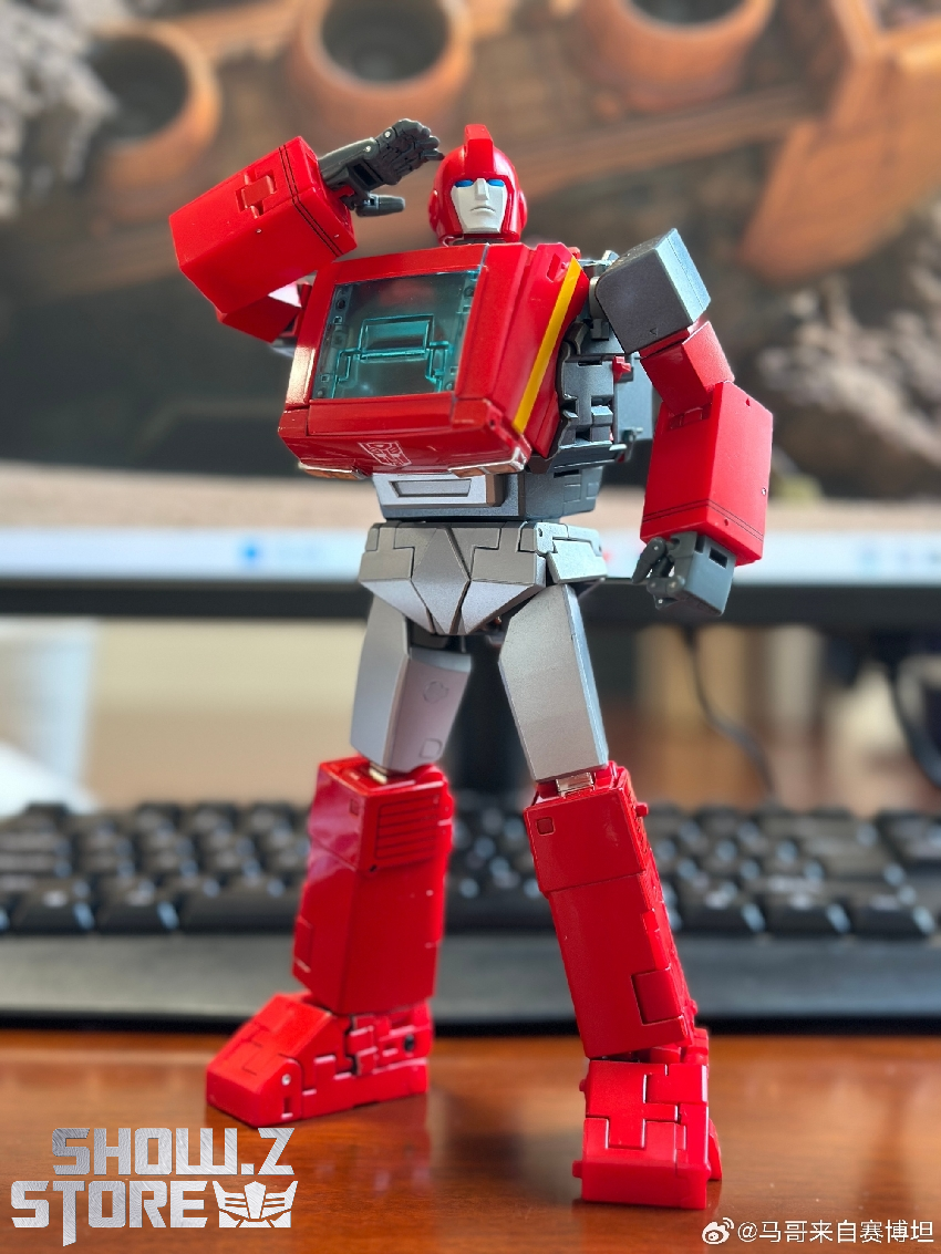 Red and grey Ironhide Transformer action figure posing with articulated limbs Red and grey Ironhide Transformer action figure posing with articulated limbs