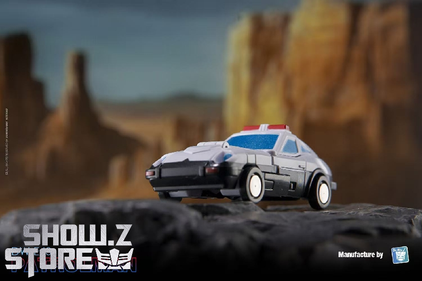White and blue police car Transformers robot in compact vehicle mode rocky terrain White and blue police car Transformers robot in compact vehicle mode rocky terrain