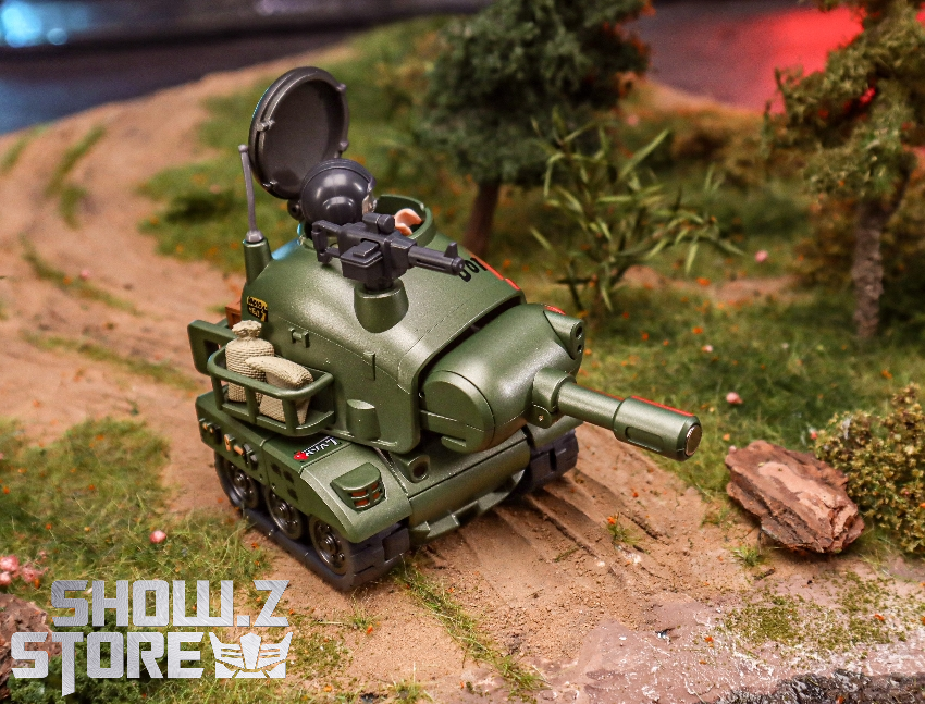 Green military transformer with weapons in scene Green military transformer with weapons in scene