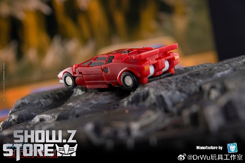 Red classic Lancia sports car die-cast model on detailed stone base Red classic Lancia sports car die-cast model on detailed stone base