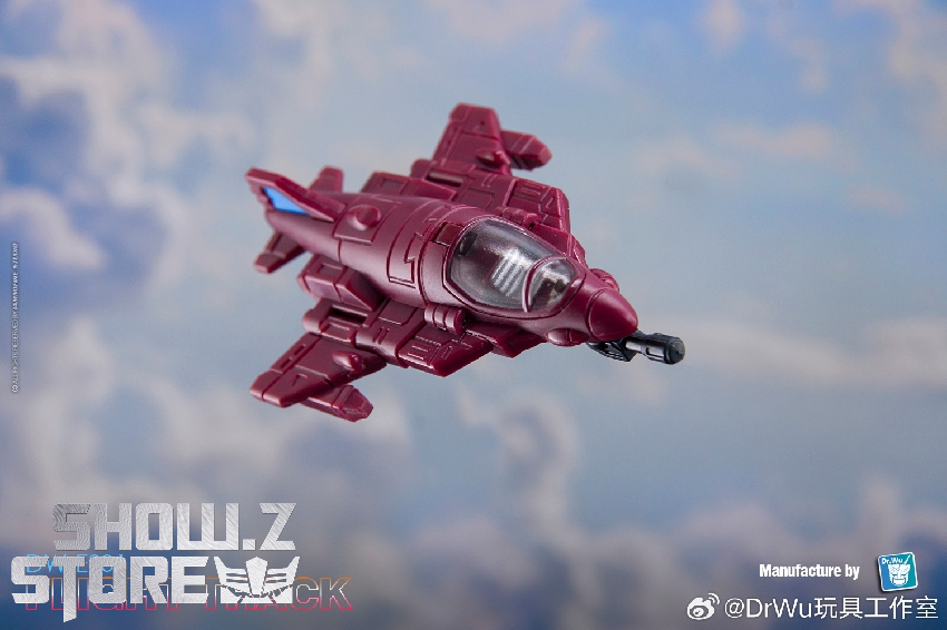 Burgundy spacecraft with delta-wing design flying through blue cloudy sky Burgundy spacecraft with delta-wing design flying through blue cloudy sky