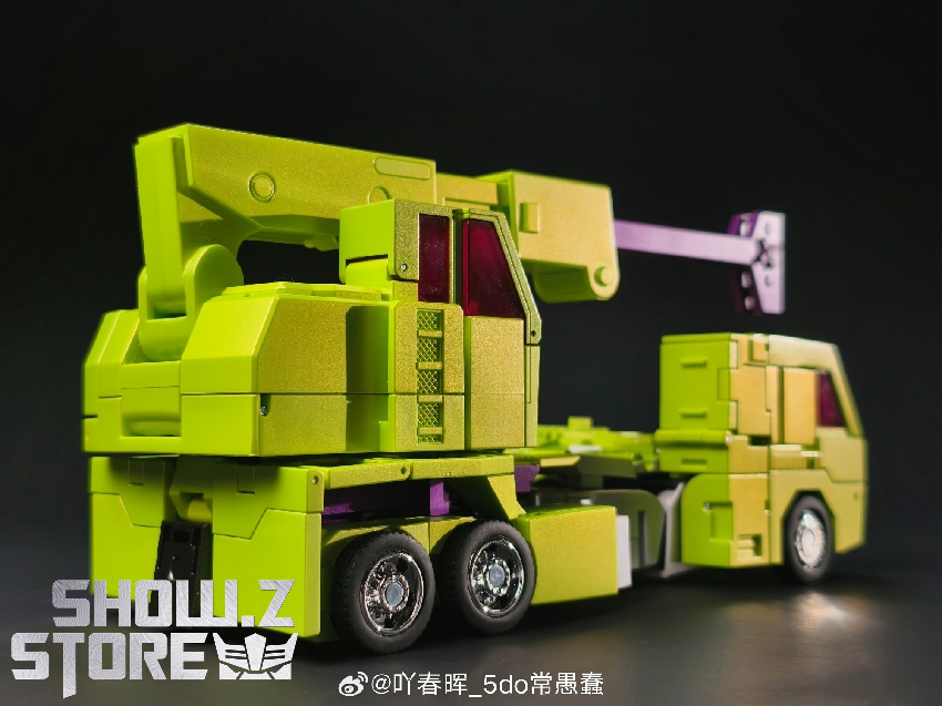 Detailed side view of yellow construction vehicle with functional hook mechanism Detailed side view of yellow construction vehicle with functional hook mechanism