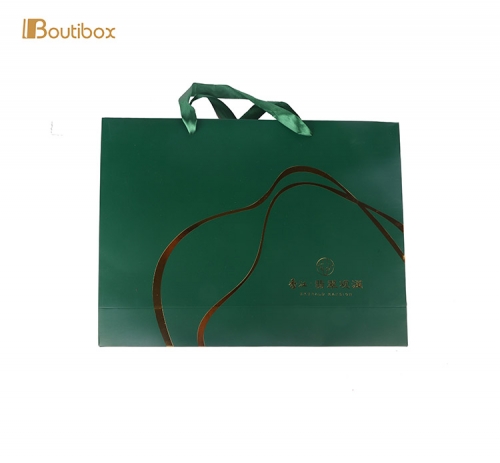 green paper bag with silk handle