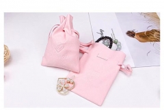 embossed logo pink suede pouch bag