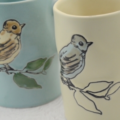 Hand-painted ceramic cups with flower and bird patterns