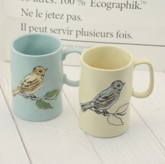 Hand-painted ceramic cups with flower and bird patterns