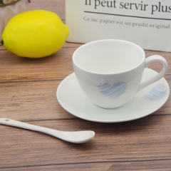 White porcelain coffee cup with base and spoon