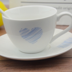 White porcelain coffee cup with base and spoon