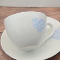 White porcelain coffee cup with base and spoon