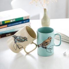 Hand-painted ceramic cups with flower and bird patterns