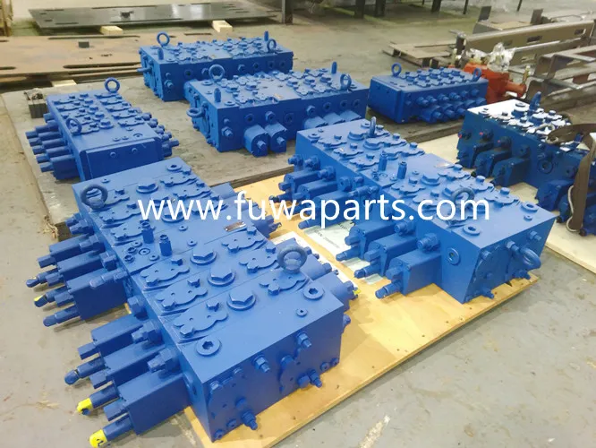 Blue hydraulic manifold blocks with plugged ports on a wooden pallet