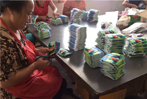 Factory workers are cutting digital printed canvas pencil bags