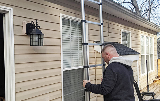 a man is opening a one button retraction ladder