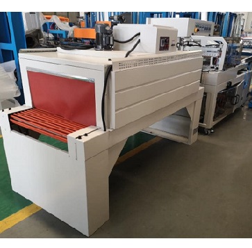 continuous motion sealing and shrink wrapping machine