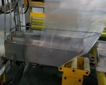 plastic film forming into bags by stainless forms on the bale shrink packing machine