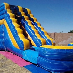 Blue and yellow bouncy castle water slide