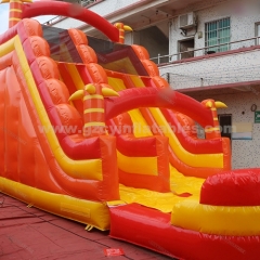 Orange inflatable bouncy castle with water double slides