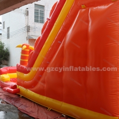 Orange inflatable bouncy castle with water double slides