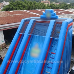 Large blue inflatable dry slide with arch
