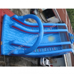 Large blue inflatable dry slide with arch