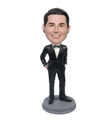 Bobble head doll with black tuxdo and bow tie